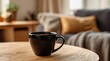 © ary24 - A dark mug of steaming coffee sits on a light wood table in a cozy living room, blurred sofa and window in the background