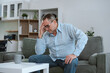 © NINENII - Senior man sitting in sofa, having depression, stress, irritability, and life problems.