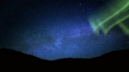 Wall Mural - aurora green and milky way galaxy over hills tilt up