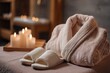 © Vitalii Shkurko - Soft textiles are complemented by warm candlelight, creating a calming ambiance in a luxurious spa setting. The robe and slippers invite relaxation and rejuvenation near the massage bed