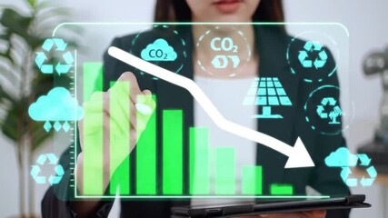 Poster - Young Woman Analyzing Carbon Reduction Bar Chart with Green Elements and Recycling Icons in Bright Office Environment