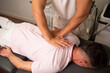 © UP - Professional young chiropractor getting a back massage