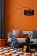 © FollowTheFlow - Modern retro living room featuring a black arc lamp, orange side table and warm-toned cushions.