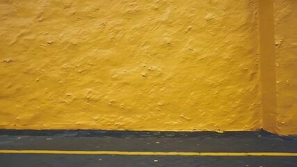Poster - Textured Yellow Wall with Dark Entryway and Minimalist Color Blocking on Floor Creates an Urban and Contemporary Design