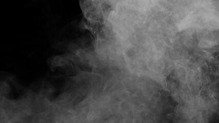 Wall Mural - large turbulent plumes of white smoke or fog swirl dynamically from left and top filling a black bac