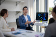 © Wasana - A man is standing in front of a computer monitor