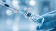 © Ali - The syringe preparing to extract vaccine from a glass vial in a clinical setting.