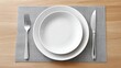 © Katsiaryna - Elegant dining setup with empty plate and cutlery on gray placemat