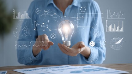 Poster - Innovative digital technology concept with a person holding a glowing light bulb surrounded by graphs charts and icons representing ideas and creativity in a modern workspace