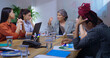 © Raushan_films - Indian young adult woman staff sitting around desk table with old aged boss ceo lady talk share bad news at job place upset female leader speak about work loss to girl group team office board room