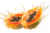 Two halves of ripe papaya with juice splash. Tropical fruit, healthy food.