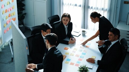 Poster - Top view of businessman explain marketing strategy and choose idea by using colorful stick notes. Professional marketing team brainstorming and planning financial plan at meeting room. Directorate.