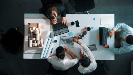 Poster - Architect team discussing and pointing and presenting blueprint to interior designer. Aerial view professional business people brainstorming building interior at table with house model. Alimentation.