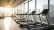 © robina - Modern gym with treadmills and large windows overlooking city skyline at sunrise