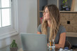 © simona - Professional young woman working in modern office with laptop and desktop computer – focused business environment, digital work, smart working and technology concept
