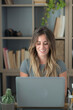 © simona - Professional young woman working in modern office with laptop and desktop computer – focused business environment, digital work, smart working and technology concept