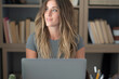 © simona - Professional young woman working in modern office with laptop and desktop computer – focused business environment, digital work, smart working and technology concept