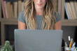 © simona - Professional young woman working in modern office with laptop and desktop computer – focused business environment, digital work, smart working and technology concept