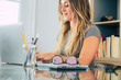 © simona - Professional young woman working in modern office with laptop and desktop computer – focused business environment, digital work, smart working and technology concept