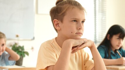Poster - Smart elementary student looking at teacher while attend in classroom. Diverse smart student sitting at classroom while listening teacher explain about classwork or test. Education concept. Pedagogy.