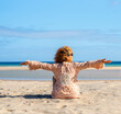 © simona - Portraits of a joyful curly-haired woman with sunglasses enjoying a summer day at the beach. Happy vacation vibes, freedom, healthy lifestyle, solo travel, outdoor fun and relaxed destination mood