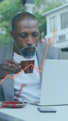 Poster - Animation of financial data processing over african american businessman using laptop
