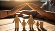 © Ashim - Photo of two hands gently create a houselike structure over a wooden family, representing family care and security