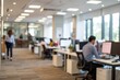 © MDABUUSUF - Blurred modern office interior with people working at desks and large windows