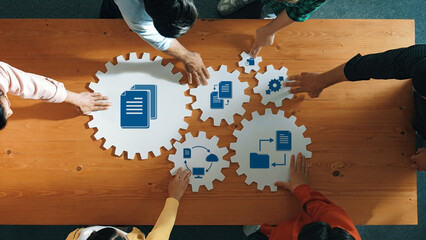 Poster - Discover a vibrant management strategy session where diverse hands collaboratively position icons on gear shapes. Visualize teamwork and innovation in a business environment. Amity