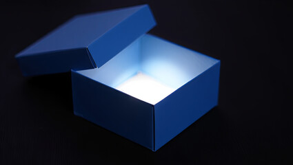 Poster - A blue box is open, revealing a soft light emanating from inside. The dark background adds to the mystery and allure of the glowing box, inviting curiosity and imagination