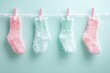 © almal - Colorful fluffy socks in pastel shades of pink and mint green hanging on a clothesline against a soft mint background, creating a cozy and playful atmosphere for winter decor