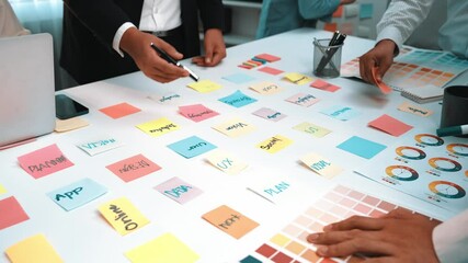Poster - A vibrant and dynamic office scene depicting a diverse team engaged in a brainstorming session, utilizing colorful sticky notes and laptops to generate innovative ideas. SACTR