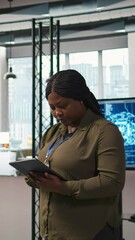 Fototapete - Vertical video Smiling female engineer next to office coworkers developing software applications, integrating AI automation. Happy woman next to developers at work debugging applications, camera A