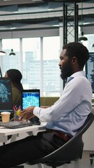 Poster - Vertical video Admin in office relies on AI machine learning to run tasks across multiple devices, monitoring progress on screens. IT expert uses neural networks to develop artificial intelligence