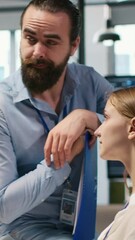 Poster - Vertical video Startup newcomer making friends in office, learning how to use machine learning tech. Upbeat young girl in workplace chatting with coworkers while using AI predictive models, camera A