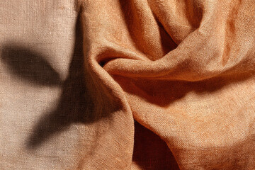 Aufkleber - Soft brown linen fabric texture with gentle folds and subtle shadow, creating warm and cozy atmosphere, perfect for textile backgrounds or interior design inspiration
