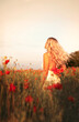 © Olya Komarova - young beautiful blonde woman in white dress in poppy field at sunset. Woman and nature