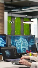 Poster - Vertical video Junior developer in office integrating AI machine learning systems to streamline workflows. Young employee uses neural networks artificial intelligence, technology overload concept