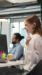 Poster - Vertical video Happy female programmer dancing on office desk chair, pleased after managing to streamline workflows with AI. Cheerful worker celebrating successfully implementing neural networks