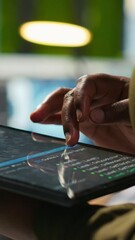 Poster - Vertical video Close up of engineer using tablet to write code, developing machine learning APIs. IT professional troubleshooting software errors and faults using artificial intelligence, camera A