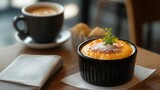 A creme brulee is served with a cup of coffee in a cafe setting