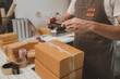 © Chadaporn - he is checking the boxes in the packing room, a small business owner is preparing boxes to ship to customers, product, e-business, entrepreneurs in online sales and export businesses
