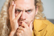© Volodymyr - Stressed man with hand on face. Close-up of young man in stress. Stress expression. Handsome male with stress. Emotional portrait of stressed guy. Dramatic stressed look. Tired and stressed face.