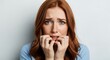 © Designer - Redhead woman shows anxiety, fear and stress while biting her nails