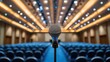 © An - Microphone in a conference room with rows of empty chairs in the background.