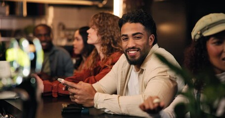 Face, man and phone with smile at pub for communication, texting and relax with message. Happy, person and portrait with smartphone for dating app, online review and networking on social media