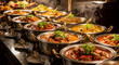 © Mirivox - Close-up of numerous steaming metal bowls filled with various curries, showcasing a vibrant buffet display, representative of a diverse and flavorful culinary experience