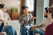 © Maria Vitkovska - African American woman leading group therapy session for mental health