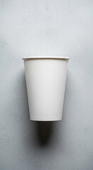 Poster - White paper cup on gray background Mockup for branding or advertisement Free space for text or logo Simple design for clean aesthetic