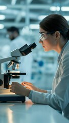 Poster - Scientific Observation: A focused scientist intently examines a specimen under a microscope in a modern laboratory environment, demonstrating precision, expertise and dedication to research.